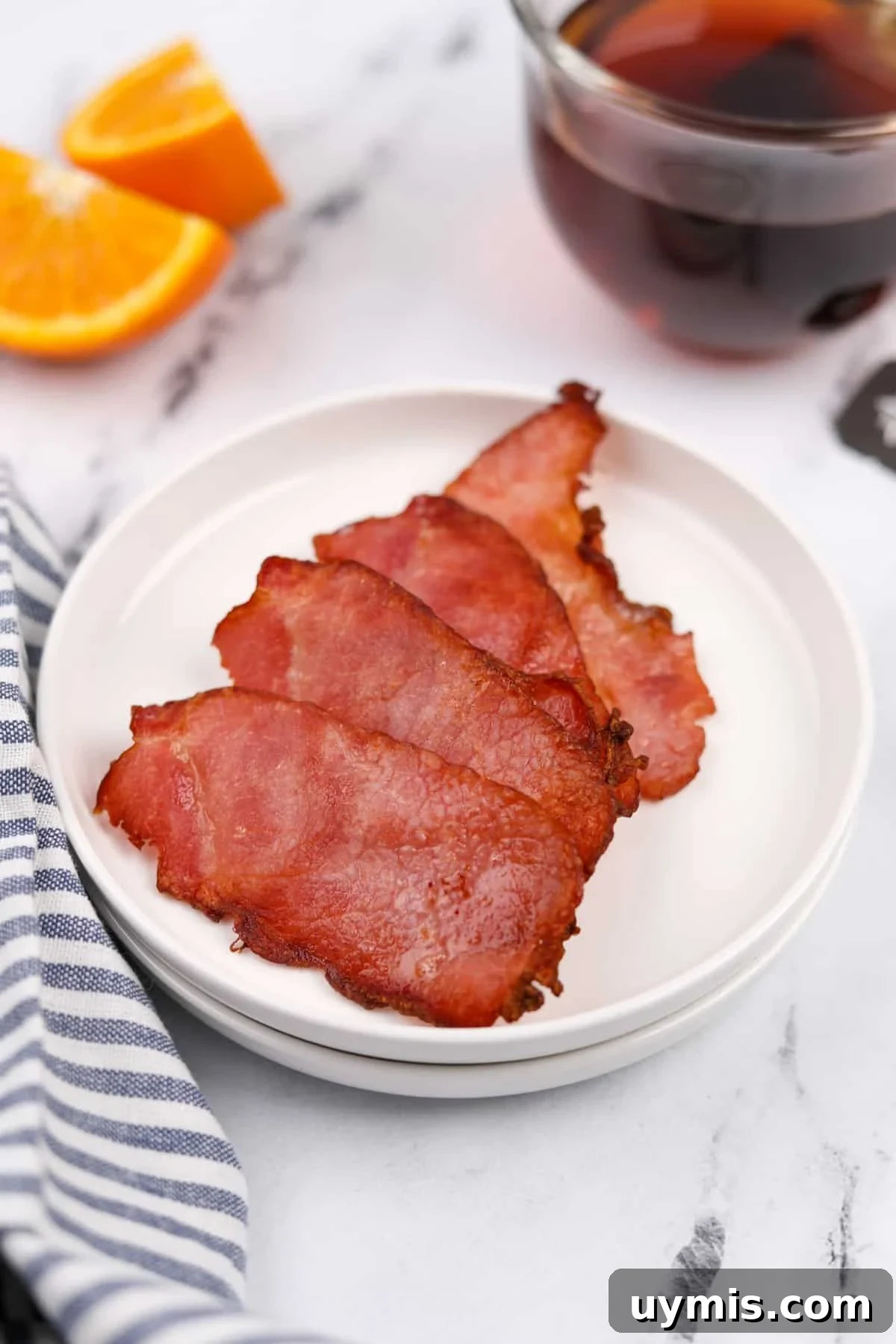 Air Fryer Canadian Bacon Breakfast Slices 2 A plate with four slices of back bacon on it.