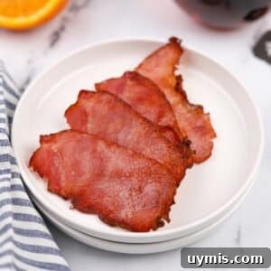 Air Fryer Canadian Bacon Breakfast Slices 12 A small plate with four crispy slices of back bacon.