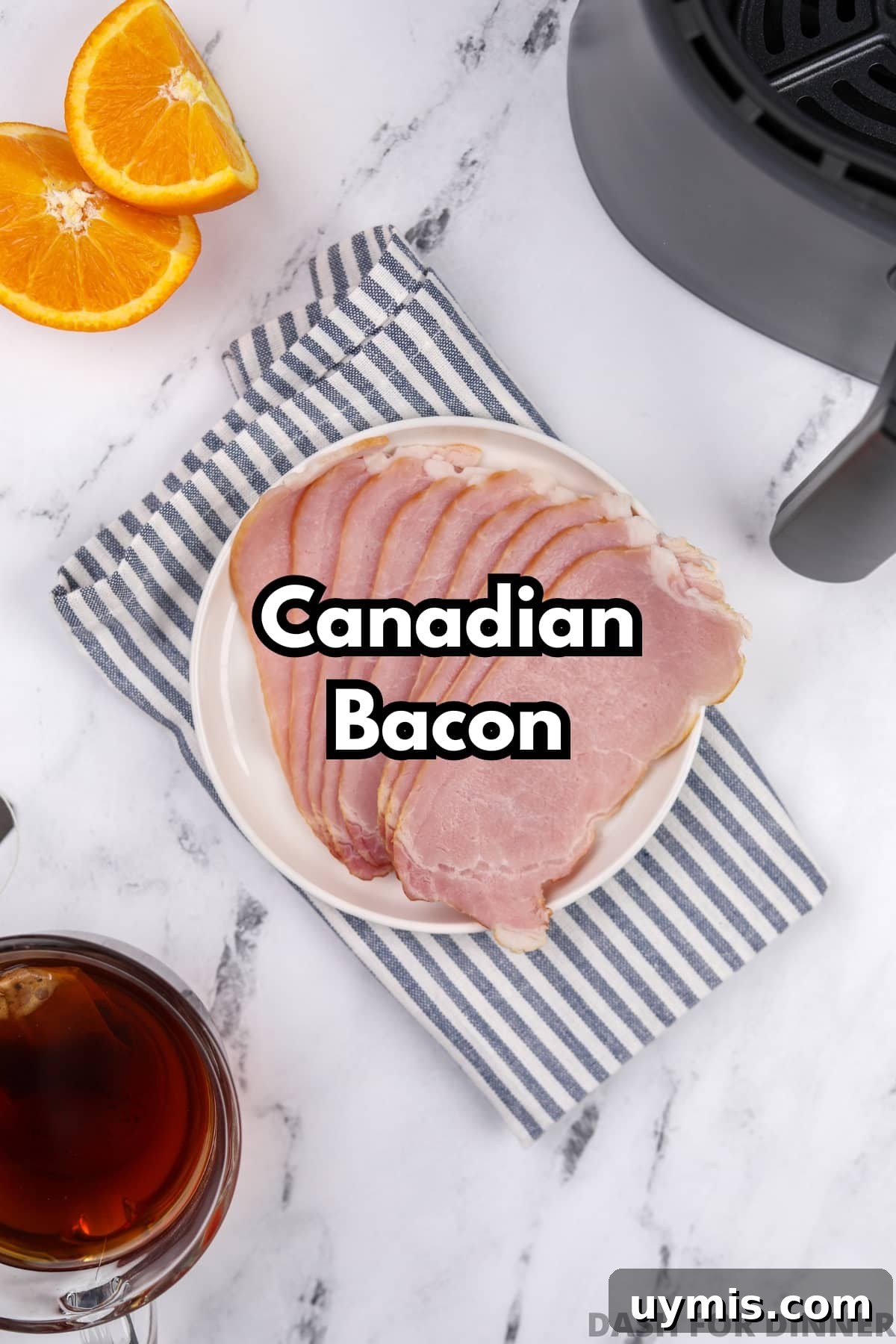 Air Fryer Canadian Bacon Breakfast Slices 3 A plate with several slices of uncooked Canadian bacon.