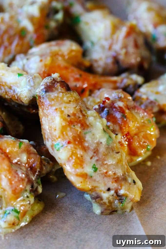 Oven baked chicken wings covered in garlic Parmesan sauce Oven baked chicken wings covered in parmesan garlic sauce