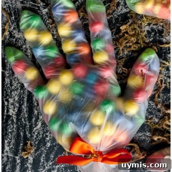 Easy Halloween Treat Bags With Candies in Gloves on Rustic Black Background